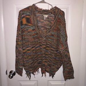 Colorful boho knit sweater with fringe hems.